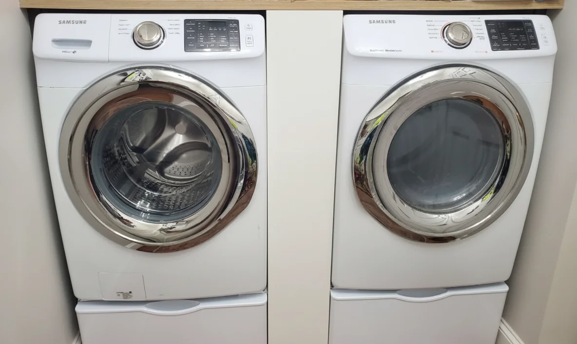 Close-up of a frustrated person with tools trying to fix a dryer